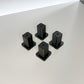 Xtool F1 Riser XL – vier schwarze Erhöhungen für die Lasergravur von Objekten.