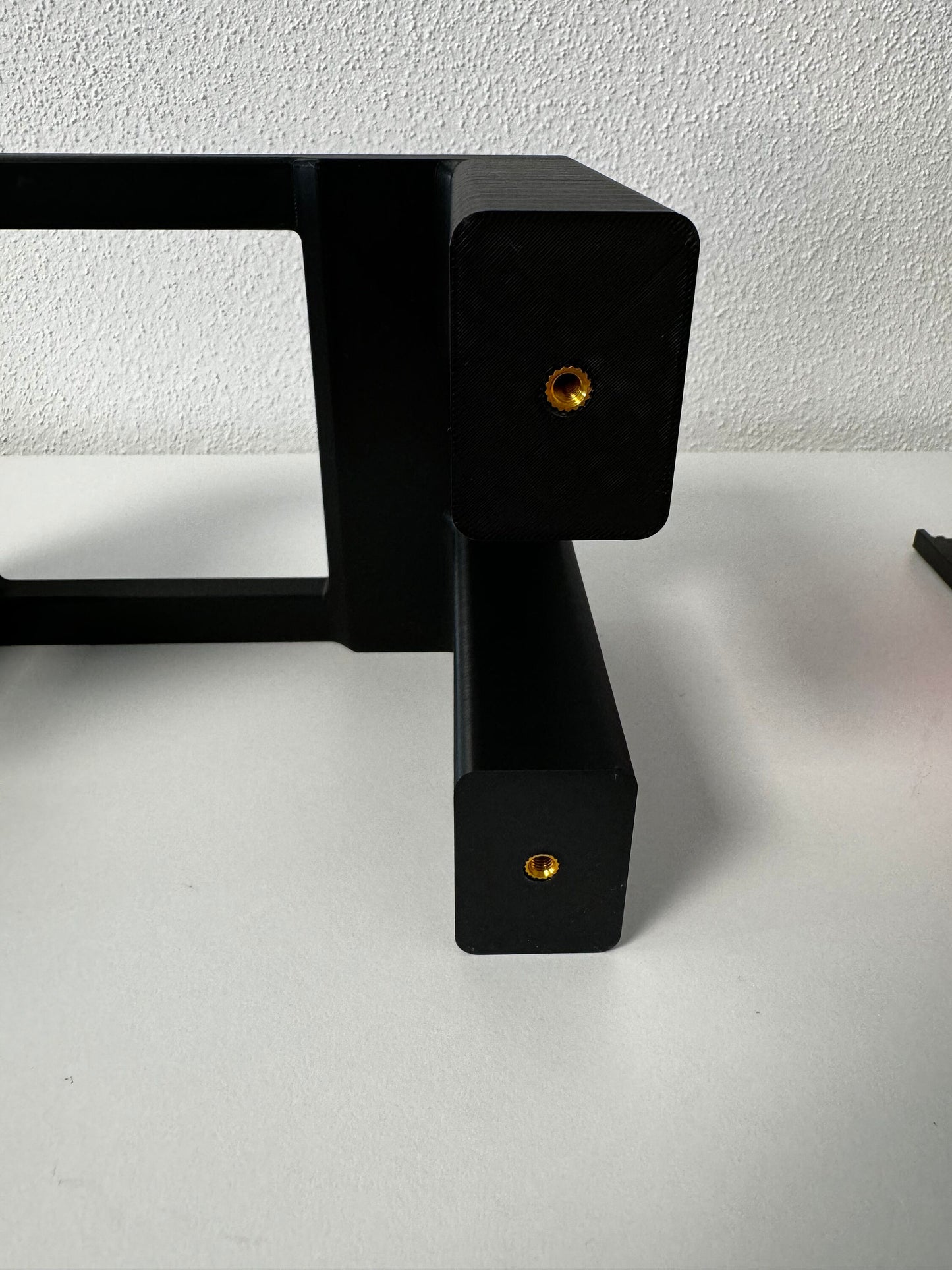 Xtool F1 Riser close-up showing the adapter for larger engraving objects with precise connectors.