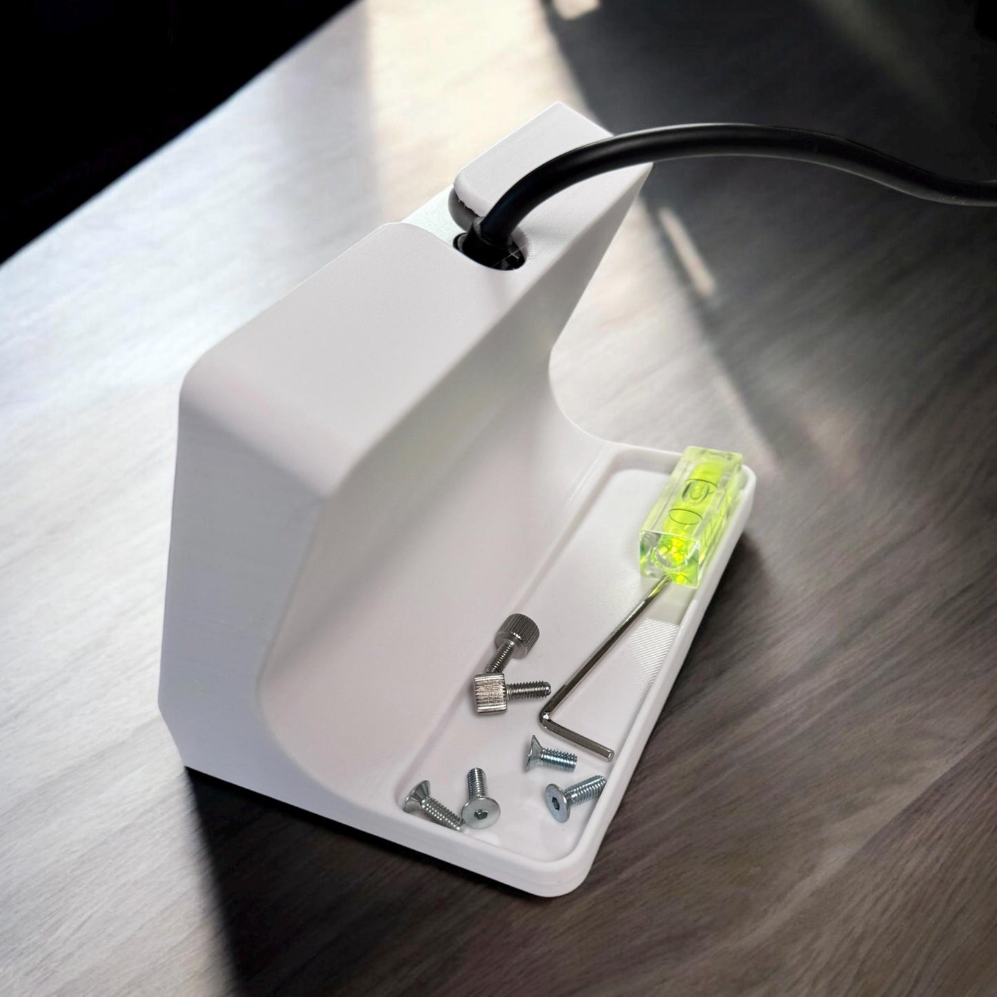 xTool F1 Ultra Stand with tools and level on a workbench, designed for ergonomic touchscreen operation.